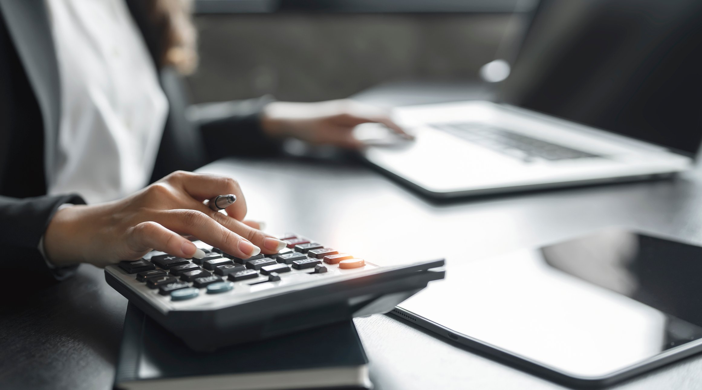 Bookkeeper on calculator and computer